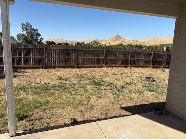 1073 Hickory St, Lindsay, CA 93247 - view of yard featuring fence, a patio area, and a mountain view