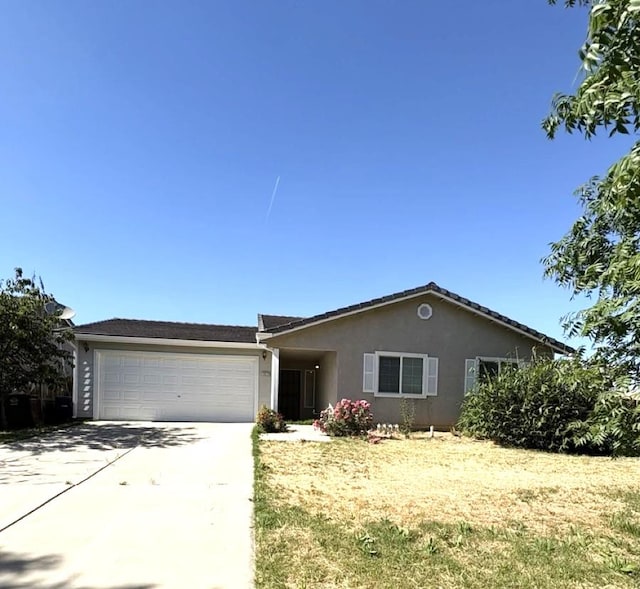 1073 Hickory St, Lindsay, CA 93247 - ranch-style house with stucco siding, an attached garage, and concrete driveway