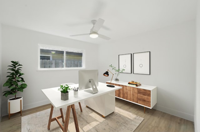 office space featuring light wood-style flooring, baseboards, and a ceiling fan