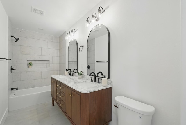 bathroom featuring toilet, washtub / shower combination, and double vanity