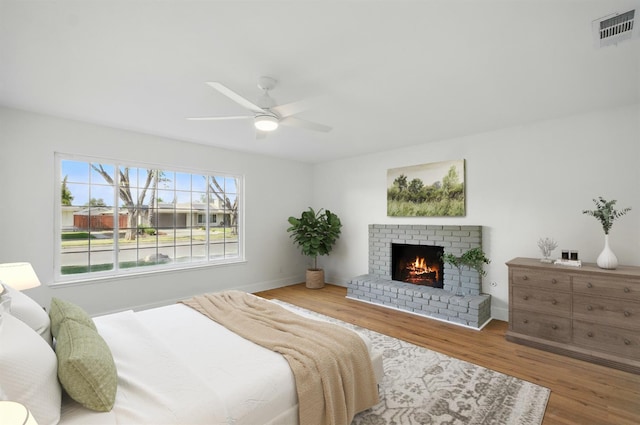 2712 Westgate Dr, Madera, CA 93637 - bedroom with wood finished floors, a fireplace, and ceiling fan