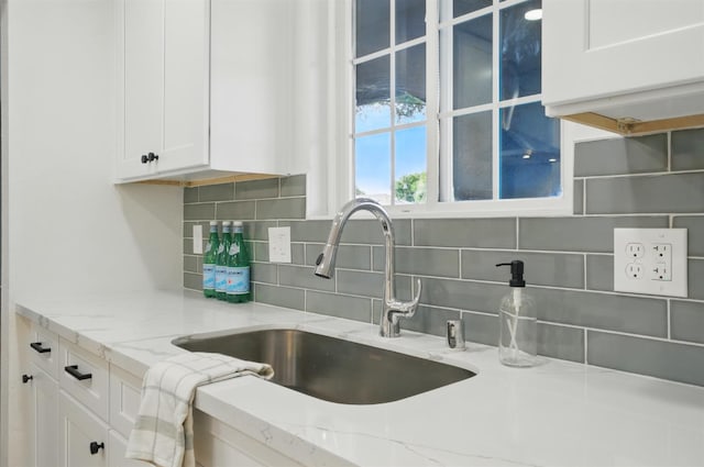 2712 Westgate Dr, Madera, CA 93637 - kitchen featuring white cabinets, decorative backsplash, and light stone countertops