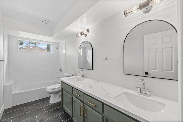 bathroom featuring toilet, double vanity, tile patterned flooring, and shower / bathtub combination