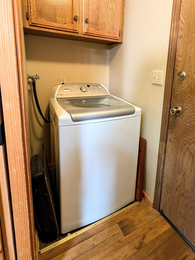 41016 Woodridge Ln, Shaver Lake, CA 93664 - laundry room with washer / clothes dryer, cabinet space, and hardwood / wood-style flooring