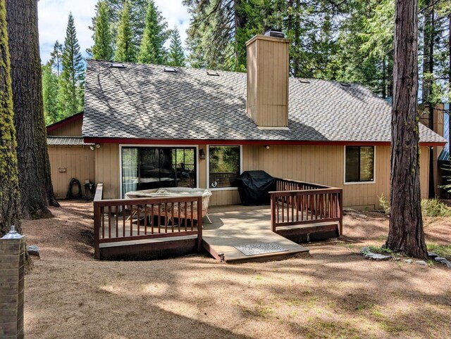 41016 Woodridge Ln, Shaver Lake, CA 93664 - back of house featuring roof with shingles, a chimney, and a deck