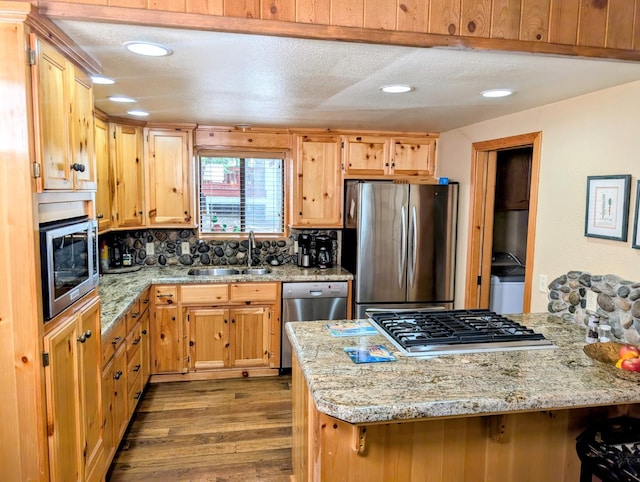 41016 Woodridge Ln, Shaver Lake, CA 93664 - kitchen with stainless steel appliances, a sink, dark wood finished floors, light stone counters, and recessed lighting