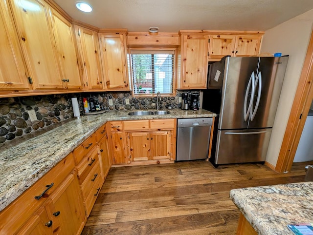 41016 Woodridge Ln, Shaver Lake, CA 93664 - kitchen with stainless steel appliances, a sink, wood finished floors, decorative backsplash, and light stone counters