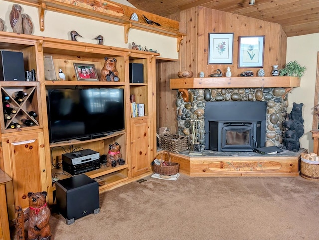 41016 Woodridge Ln, Shaver Lake, CA 93664 - living area featuring vaulted ceiling, carpet floors, wooden ceiling, wood walls, and a wood stove