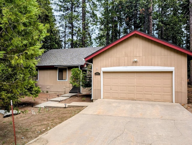 41016 Woodridge Ln, Shaver Lake, CA 93664 - single story home featuring driveway, roof with shingles, and an attached garage