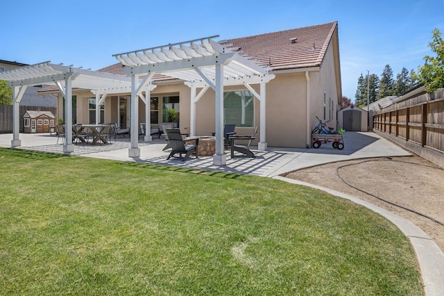 2506 20th Ave, Kingsburg, CA 93631 - rear view of house with a shed, a patio, a pergola, stucco siding, and an outbuilding