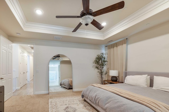 2506 20th Ave, Kingsburg, CA 93631 - bedroom with crown molding, light carpet, a tray ceiling, arched walkways, and baseboards
