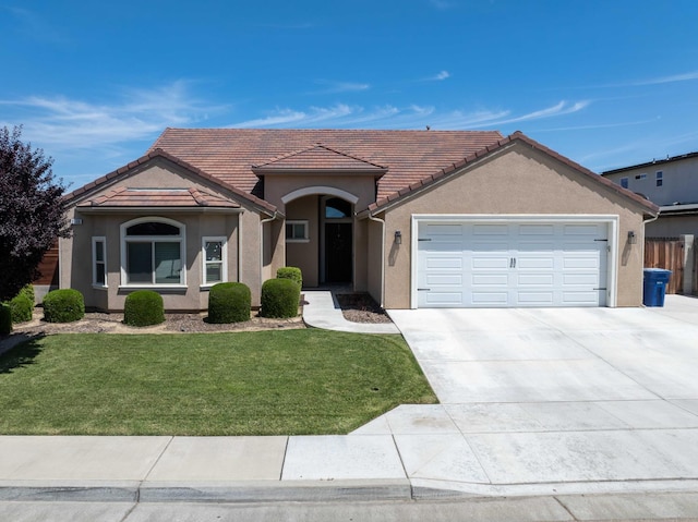 2506 20th Ave, Kingsburg, CA 93631 - view of front of house featuring an attached garage, a front yard, driveway, stucco siding, and a tiled roof