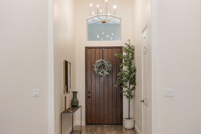 2506 20th Ave, Kingsburg, CA 93631 - foyer entrance featuring a chandelier, baseboards, wood finished floors, and a towering ceiling