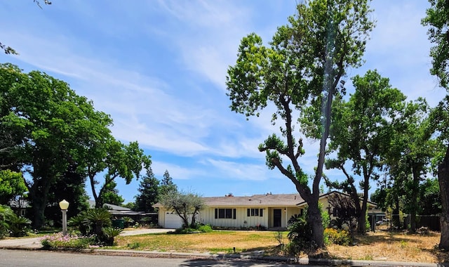 5850 E Parkside Dr, Fresno, CA 93727 - ranch-style house featuring an attached garage, concrete driveway, and board and batten siding