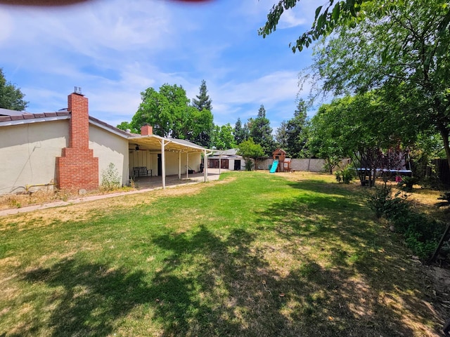 5850 E Parkside Dr, Fresno, CA 93727 - view of yard featuring a trampoline, a playground, a patio, and ceiling fan