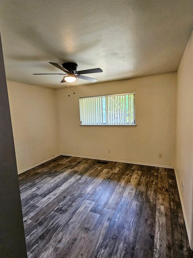5850 E Parkside Dr, Fresno, CA 93727 - unfurnished room featuring dark wood-type flooring, ceiling fan, a textured ceiling, and baseboards