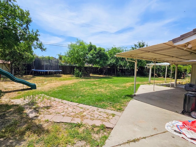5850 E Parkside Dr, Fresno, CA 93727 - view of yard with a trampoline, a patio area, and a playground
