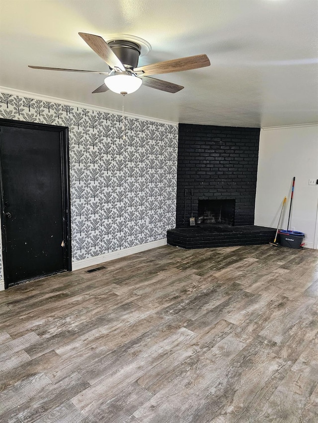 5850 E Parkside Dr, Fresno, CA 93727 - unfurnished living room featuring wood finished floors, ceiling fan, crown molding, a brick fireplace, and baseboards