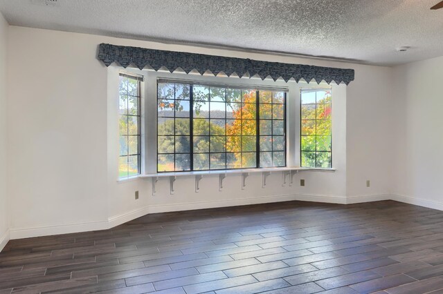 42177 Lone Olive Ln, Ahwahnee, CA 93601 - empty room featuring dark wood finished floors, a textured ceiling, baseboards, and a smoke detector