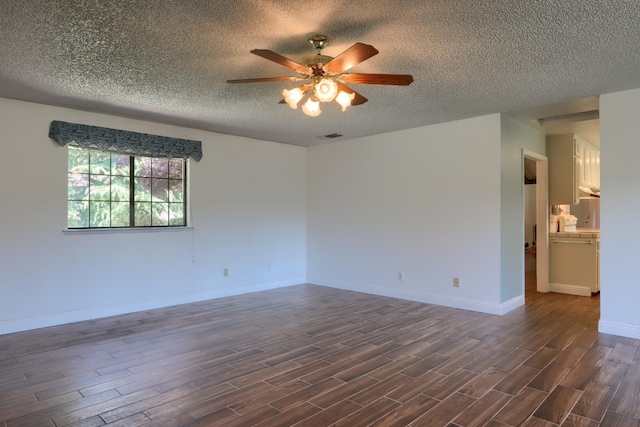 42177 Lone Olive Ln, Ahwahnee, CA 93601 - spare room with ceiling fan, a textured ceiling, dark wood-type flooring, and baseboards