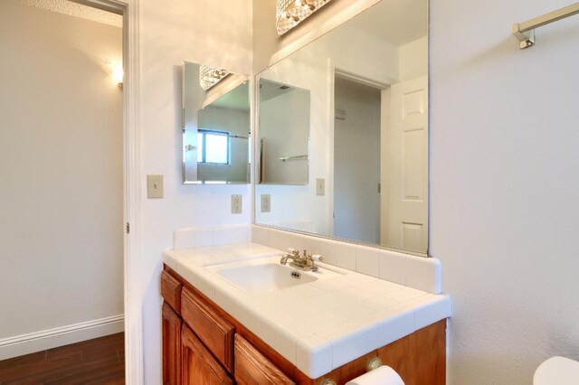 42177 Lone Olive Ln, Ahwahnee, CA 93601 - bathroom featuring wood finished floors, vanity, and baseboards