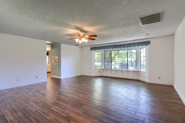 42177 Lone Olive Ln, Ahwahnee, CA 93601 - unfurnished room with a ceiling fan, dark wood-type flooring, a textured ceiling, and baseboards