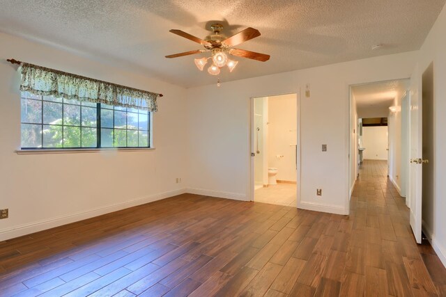 42177 Lone Olive Ln, Ahwahnee, CA 93601 - unfurnished bedroom with wood finished floors, a textured ceiling, baseboards, connected bathroom, and a ceiling fan