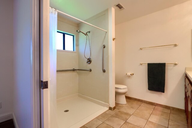 42177 Lone Olive Ln, Ahwahnee, CA 93601 - full bath with curtained shower, toilet, vanity, baseboards, and tile patterned flooring