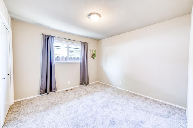 empty room with carpet floors and baseboards