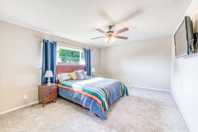 bedroom featuring light colored carpet, baseboards, and ceiling fan