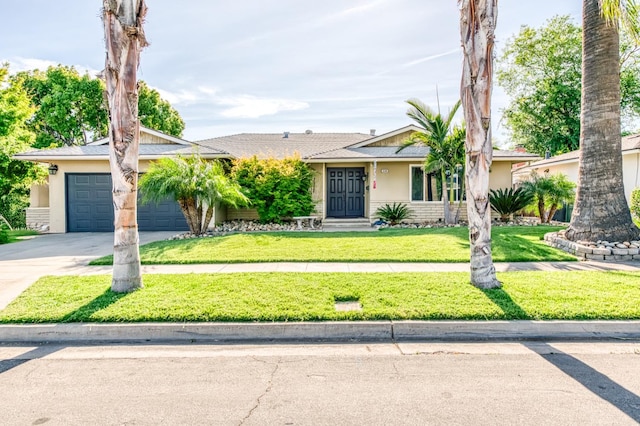 ranch-style home featuring driveway, stucco siding, a garage, and a front yard