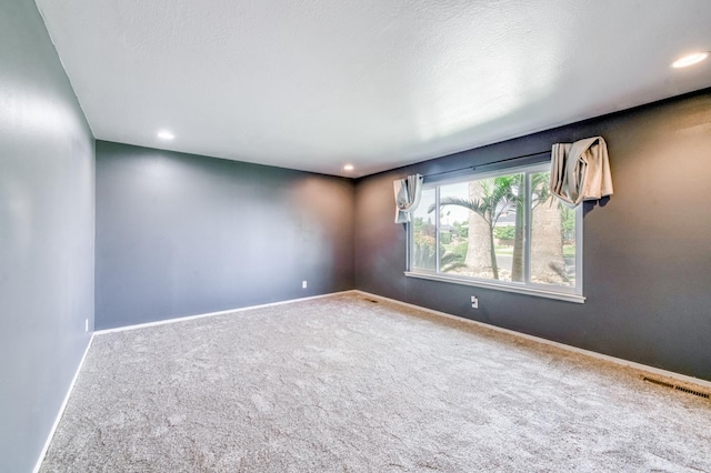 carpeted empty room with recessed lighting and baseboards