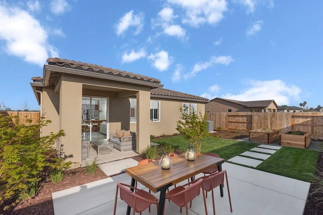 2173 Sylmar Ave, Fresno, CA 93725 - view of patio with a garden, fence, outdoor dining area, and central AC unit