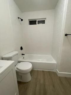bathroom with wood finished floors, toilet, bathing tub / shower combination, vanity, and baseboards