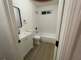 full bathroom featuring toilet, wood finished floors, vanity, and washtub / shower combination