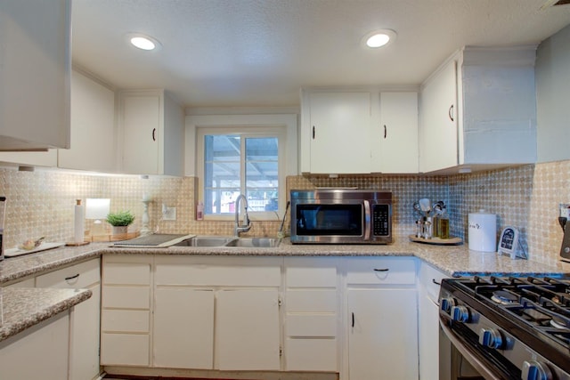 431 S Laurel, Turlock, CA 95380 - kitchen with stainless steel appliances, a sink, white cabinets, light countertops, and recessed lighting