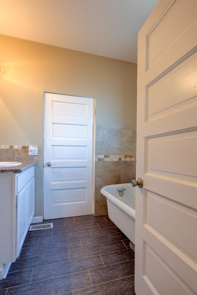 431 S Laurel, Turlock, CA 95380 - bathroom with wood finished floors, a freestanding tub, tile walls, and vanity