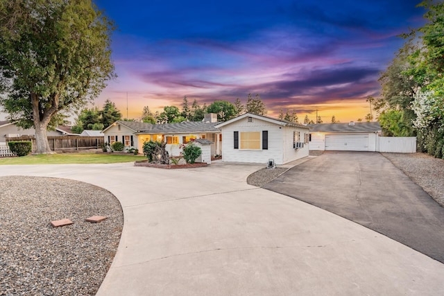 single story home with asphalt driveway and a garage