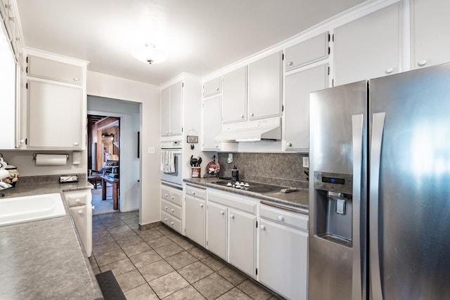 kitchen featuring stainless steel fridge with ice dispenser, white oven, black electric stovetop, under cabinet range hood, and light tile patterned flooring