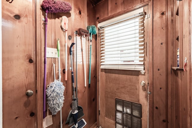 doorway to outside with wooden walls