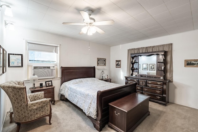 carpeted bedroom with a ceiling fan and cooling unit