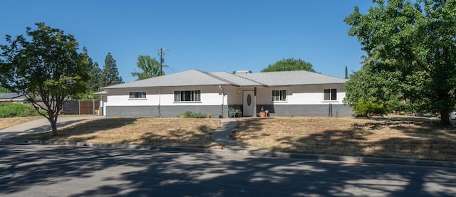 single story home featuring fence