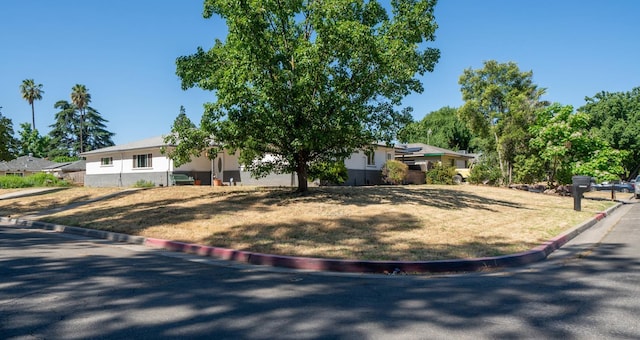 view of front of house featuring stucco siding and a front yard