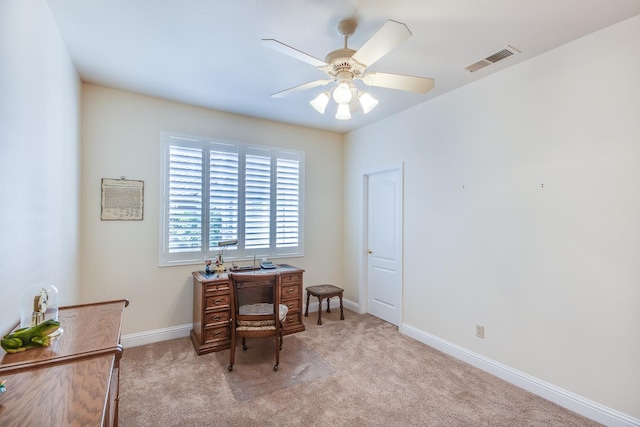 carpeted office with ceiling fan and baseboards