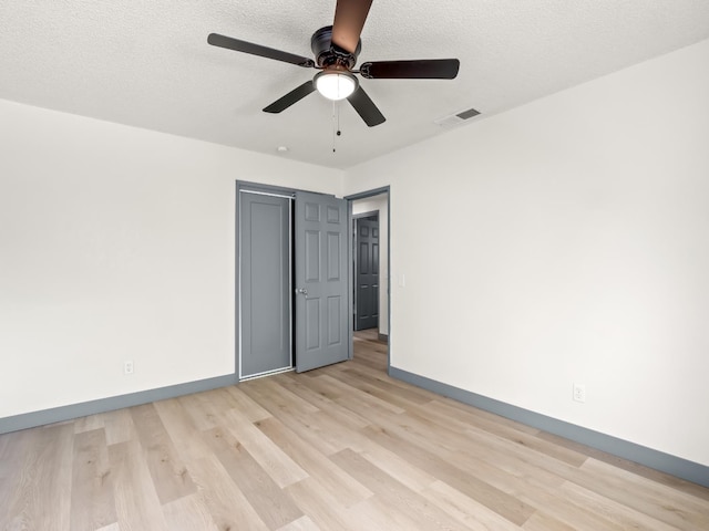 4038 W San Jose Ave, Fresno, CA 93722 - unfurnished bedroom with light wood-style flooring, baseboards, a ceiling fan, a textured ceiling, and a closet