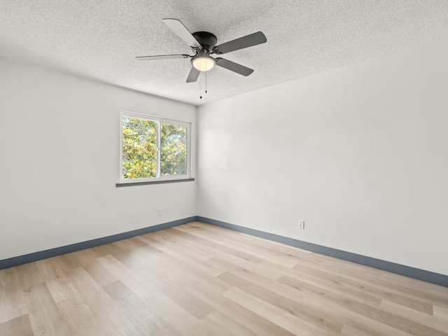 4038 W San Jose Ave, Fresno, CA 93722 - spare room with light wood-type flooring, a textured ceiling, a ceiling fan, and baseboards