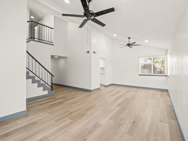4038 W San Jose Ave, Fresno, CA 93722 - unfurnished living room featuring a ceiling fan, recessed lighting, stairs, light wood-style flooring, and baseboards