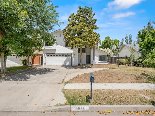 4038 W San Jose Ave, Fresno, CA 93722 - view of front of house with fence, concrete driveway, and a garage