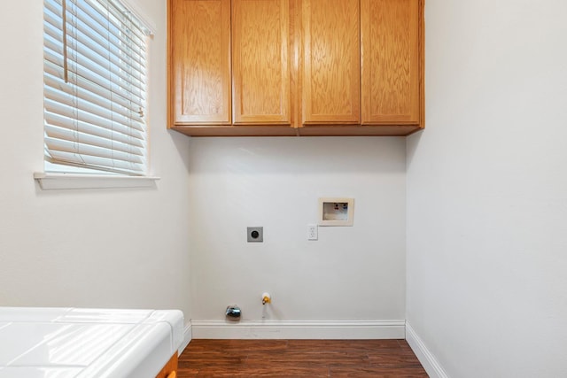 6371 N Babigian Ave, Fresno, CA 93722 - clothes washing area featuring baseboards, dark wood-style floors, washer hookup, and cabinet space