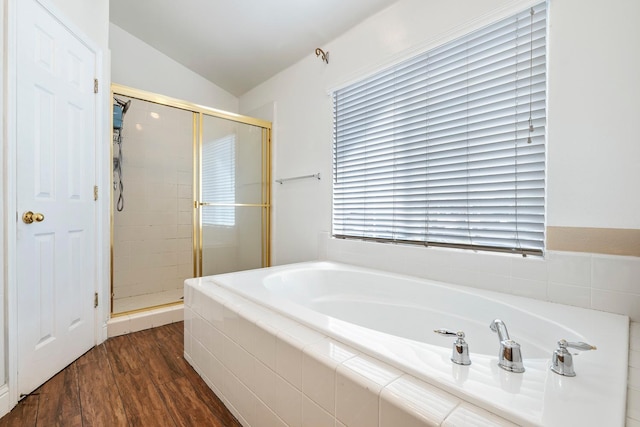 6371 N Babigian Ave, Fresno, CA 93722 - bathroom featuring vaulted ceiling, a shower stall, a bath, and wood finished floors